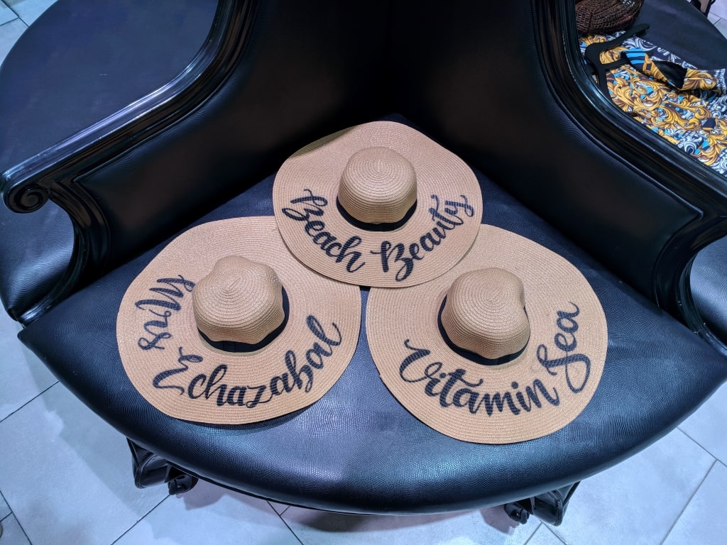 3 ladies hats with painted letters on them