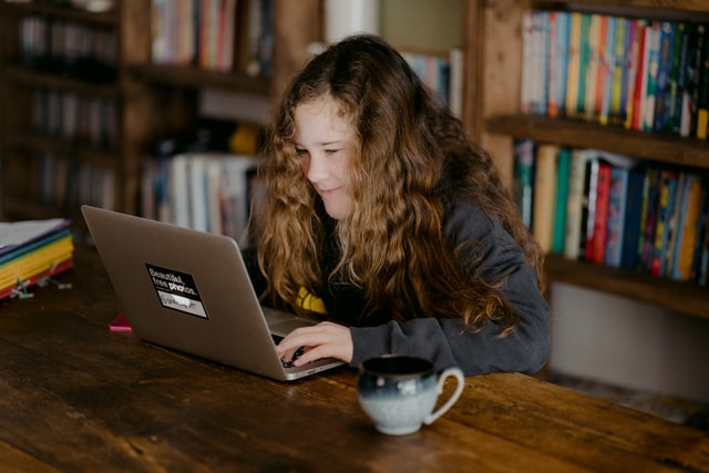 girl sitting in front of laptop