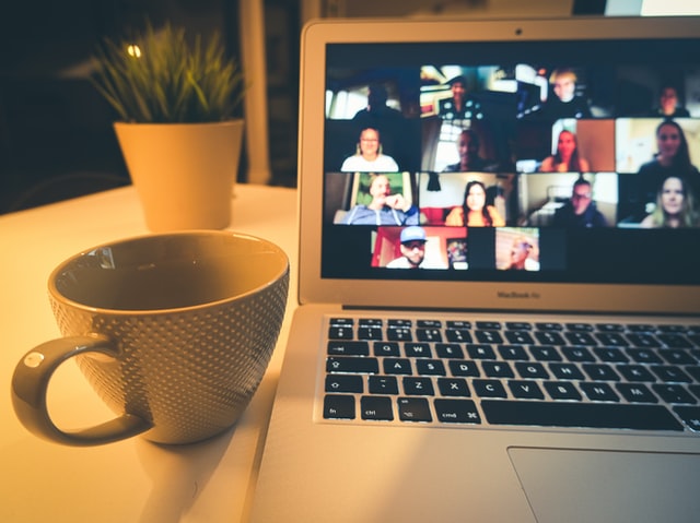 macbook air displaying a woman in white shirt -