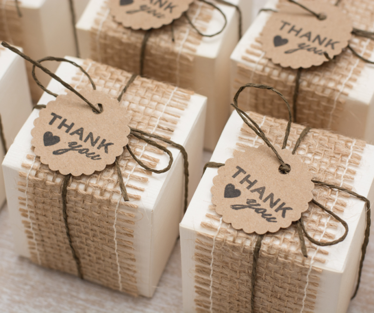 bars of handmade soap wrapped in ribbon with a tag saying thank you