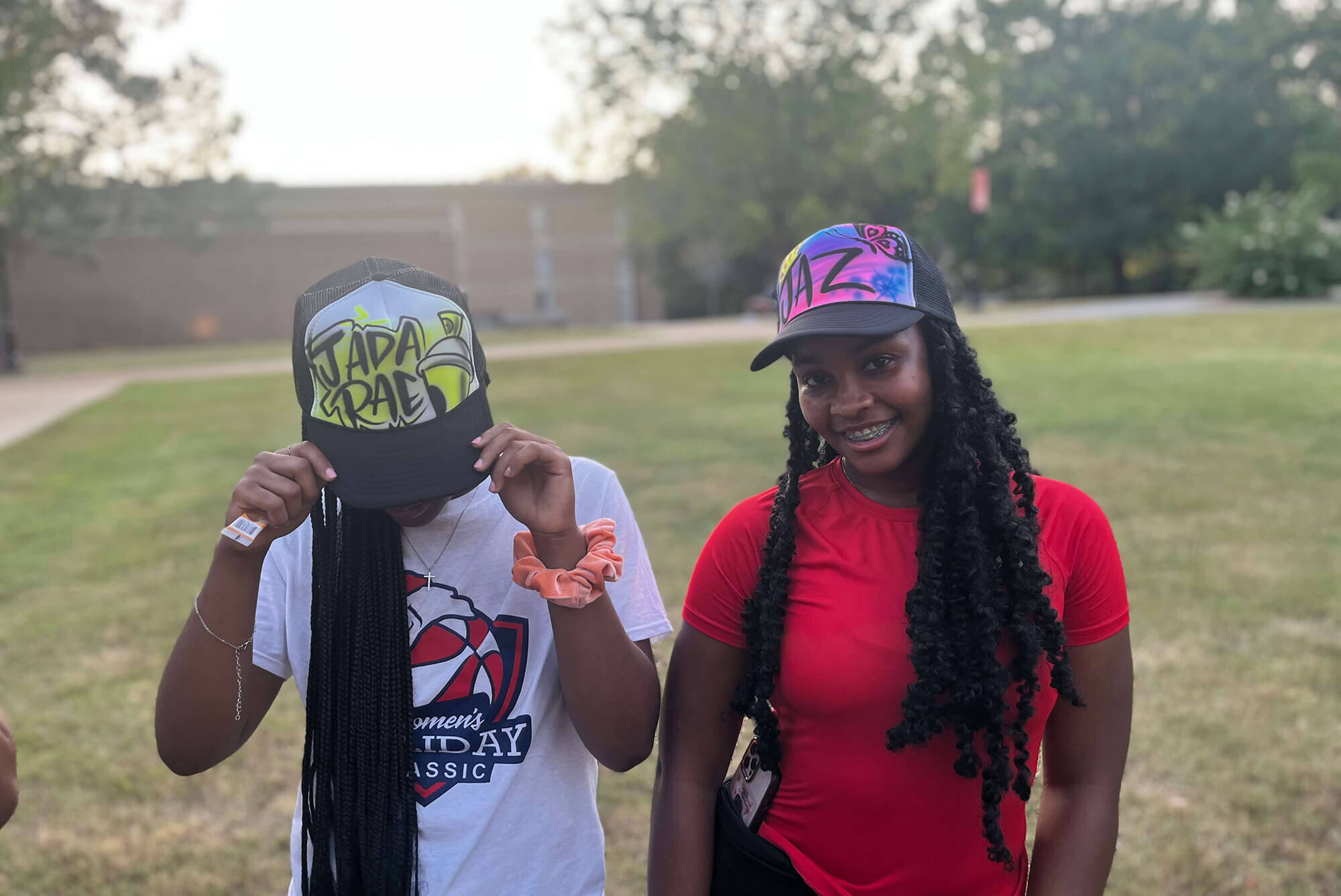 Women with custom Airbrush Events trucker hats.