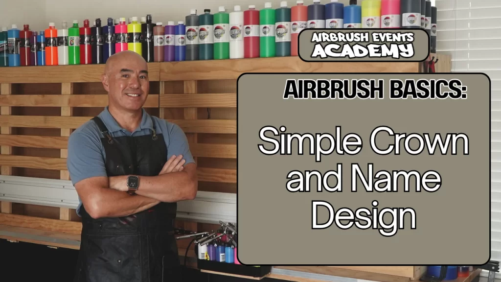 Airbrush instructor stands in front of a large wooden easel that has bottles of paint lined on the top.